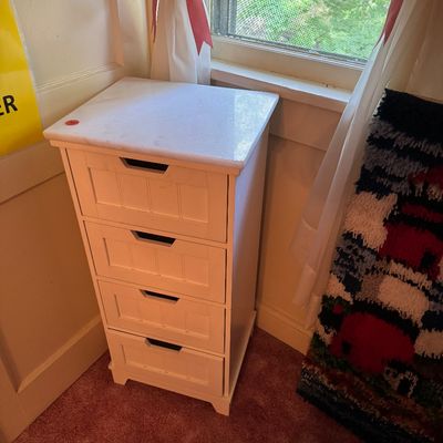 White wooden four-drawer storage chest featuring a white marble top and integrated drawer pulls, 