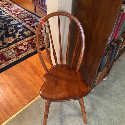 Vintage Windsor-style wooden dining chair with a hoop back, spindle supports, and turned legs.