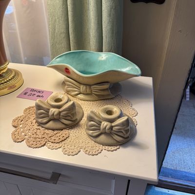 Vintage mid-century ceramic console set featuring a turquoise-lined bowl and matching pair of low candlesticks, all adorned with sculpted...