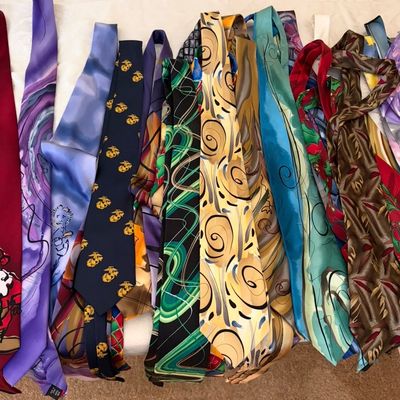 Sale Photo Thumbnail #53: Collection of vintage and novelty silk neckties featuring various patterns, including abstract swirls, holiday themes, and a U.S. Marine Corps emblem.