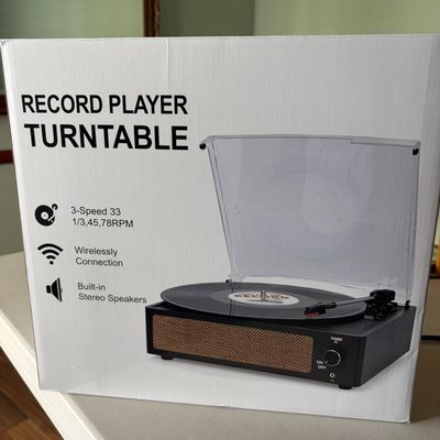 Sale Photo Thumbnail #36: Modern 3-speed record player turntable with wireless connection and built-in stereo speakers, shown new in its original packaging.