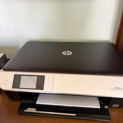 Sale Photo Thumbnail #32: HP Envy 5000 series all-in-one printer, scanner, and copier, featuring a black and silver design with a digital display screen.