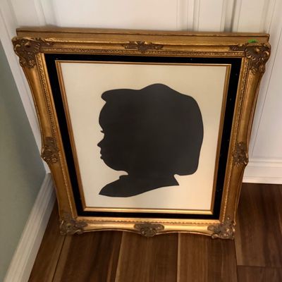 Sale Photo Thumbnail #75: Vintage framed silhouette portrait of a child, housed in an ornate, gilded gesso frame with black velvet matting.