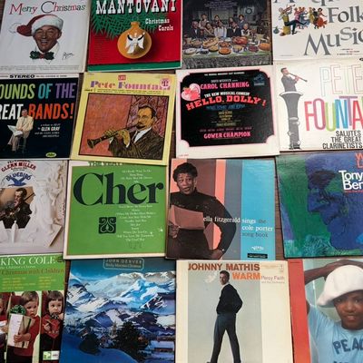 Sale Photo Thumbnail #35: Collection of vintage vinyl LP records featuring artists such as Cher, Ella Fitzgerald, Tony Bennett, and Johnny Mathis, showing some wear on the sleeves.