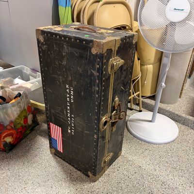 Sale Photo Thumbnail #78: Vintage military footlocker trunk belonging to a USMC Warrant Officer, featuring brass hardware, stenciled name, and an American flag decal.
