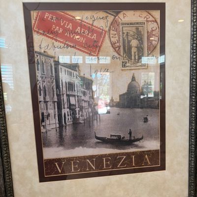 Sale Photo Thumbnail #54: Framed vintage-style Venezia travel collage print, featuring a gondola on the Venice canals, postage stamps, and cursive script, presented in a matted frame.
