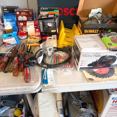 Sale Photo Thumbnail #76: Assortment of garage and workshop items, including hand tools, light bulbs, an electric pump, a Bosch hard case, and a DeWalt box.