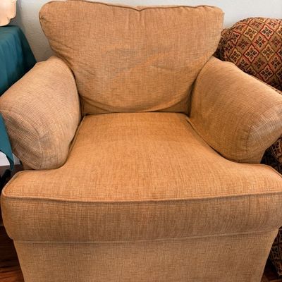 Sale Photo Thumbnail #38: Contemporary oversized armchair upholstered in a textured, golden-tan fabric with thick rolled arms and a loose back cushion.