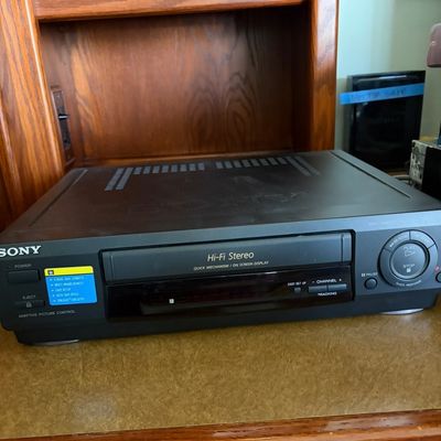 Sale Photo Thumbnail #37: Sony Hi-Fi Stereo VCR with Adaptive Picture Control, featuring a black casing and front-panel controls, circa late 1990s.