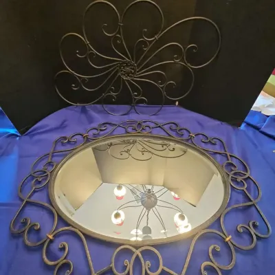 Ornate Oval Wall Mirror With Wrought Iron Style Scrollwork Frame And Metal Wall Decor
