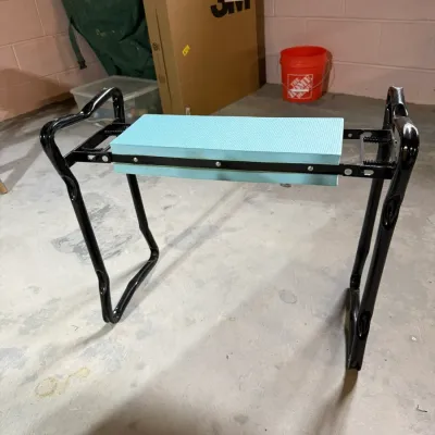 Folding garden kneeler and bench with a black metal frame and a light blue foam pad, shown in good, functional condition.
