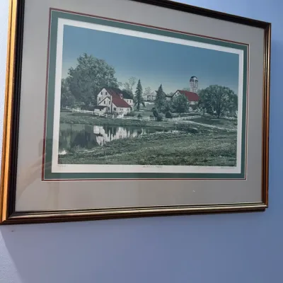 Framed and matted limited edition print titled "Witness Tree" by P. Buckley Moss, depicting a rural farm scene with a pond,...