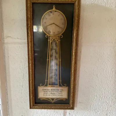 Vintage Chicco Beverage Co. advertising wall clock and thermometer combination, housed in a rectangular gold-painted frame.