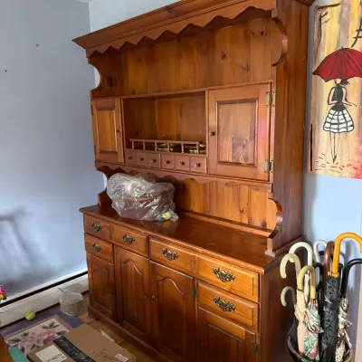 Vintage pine Welsh dresser hutch featuring a scalloped top valance, open shelving, small spice drawers, and a lower cabinet base with...