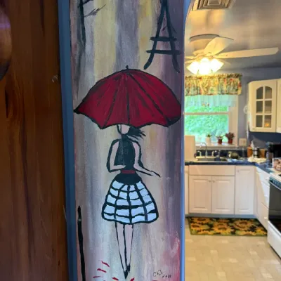 Vertical panel painting depicting a woman with a red umbrella in Paris, signed and dated 2018.