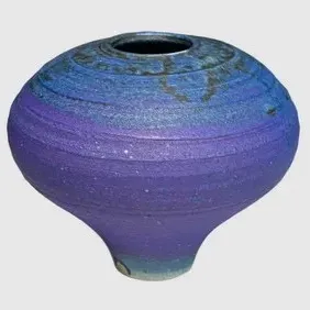 Studio art pottery vase by Charles Halling featuring a textured, ribbed surface with a vibrant blue and purple gradient glaze.