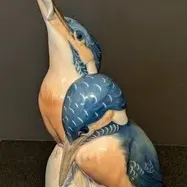 Vintage Royal Copenhagen porcelain figurine depicting two kingfishers, featuring detailed blue and peach plumage with a glossy finish.