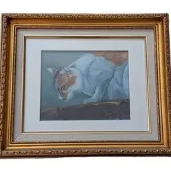 Framed painting of a calico and white cat peering downward, housed in an ornate gold-finished frame with a double mat.