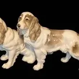 Porcelain Spaniel Figurine - Hutschenreuther Two-Dog Sculpture. 
Pair of vintage ceramic spaniel dog figurines, featuring a glossy white...