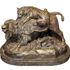 Bronze sculpture depicting a tiger attacking a buffalo, mounted on a marble base, in the style of 19th-century French animalier bronzes.