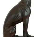 Vintage bronze-finished sculpture of a sitting greyhound or whippet on a rectangular base.