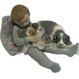 Porcelain Figurine "Sweet Dreams" by Lladró.

Lladro porcelain figurine depicting a young boy sleeping with a dog and puppies,...