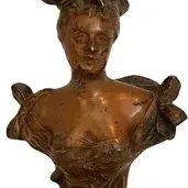Antique bronze-finished plaster or metal bust of a Victorian-era woman wearing an elaborate hat, showing some surface wear and patina.