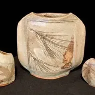 Three-piece studio art pottery set featuring a large pillow vase with pine needle impressions and two smaller vessels with leaf...