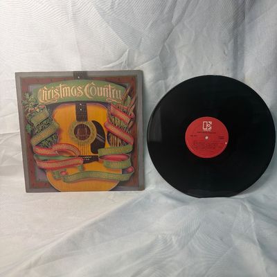 Sale Photo Thumbnail #65: Vintage 'Christmas Country' compilation vinyl record album released by Elektra Records (1981). Features holiday tracks by various country artists including Hank Williams Jr., Johnny Lee, Mel Tillis, and more. Includes the original album jacket and the 12-
