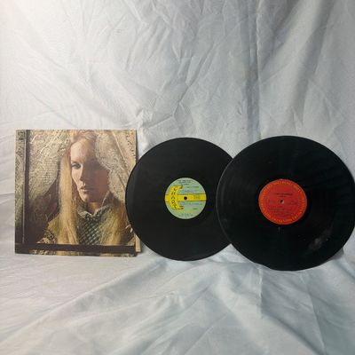 Sale Photo Thumbnail #53: Two vintage Lynn Anderson 12-inch vinyl LP records. Includes the album 'Cry' (Columbia Records) with its original sleeve, and a 'Greatest Hits' compilation on the Chart Records label. The records show some light surface wear and dust from age, and the alb