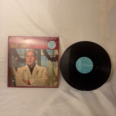 Sale Photo Thumbnail #7: Vintage vinyl record album featuring 'Perry Como Sings Merry Christmas Music' released on the RCA Camden label. Includes the original album jacket, which remains partially in its original shrink wrap with a vintage discount price sticker on the front. The