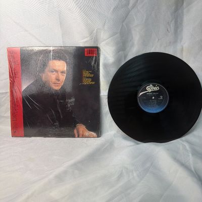 Sale Photo Thumbnail #38: Mickey Gilley "One And Only" vinyl record album, released on Epic Records. Includes the original album jacket, which remains partially in its original shrink wrap. The vinyl disc is visually in good condition with minor surface wear consistent with age an