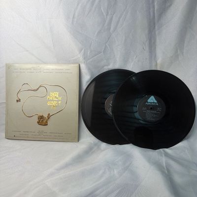 Sale Photo Thumbnail #24: Barry Manilow Greatest Hits double vinyl LP set released on Arista Records. Includes the original gatefold jacket with hype sticker on the front. The vinyl records show light surface wear and dust from age, and the jacket has minor edge and corner wear. F