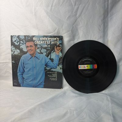 Sale Photo Thumbnail #59: A vintage 12-inch vinyl record of "Bill Anderson's Greatest Hits Vol. 2" released on Decca Records (DL 75215). The stereophonic LP features classic country tracks. Includes the original album cover sleeve showing some light edge wear. The vinyl disc appea