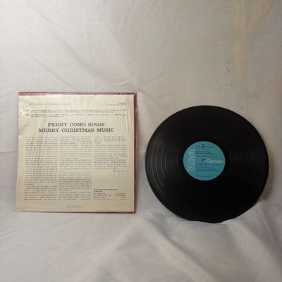 Sale Photo Thumbnail #8: Vintage vinyl record album featuring 'Perry Como Sings Merry Christmas Music' released on the RCA Camden label. Includes the original album jacket, which remains partially in its original shrink wrap with a vintage discount price sticker on the front. The