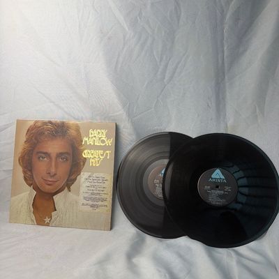 Sale Photo Thumbnail #23: Barry Manilow Greatest Hits double vinyl LP set released on Arista Records. Includes the original gatefold jacket with hype sticker on the front. The vinyl records show light surface wear and dust from age, and the jacket has minor edge and corner wear. F