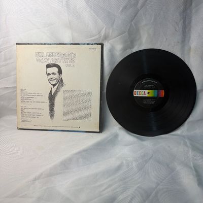 Sale Photo Thumbnail #60: A vintage 12-inch vinyl record of "Bill Anderson's Greatest Hits Vol. 2" released on Decca Records (DL 75215). The stereophonic LP features classic country tracks. Includes the original album cover sleeve showing some light edge wear. The vinyl disc appea
