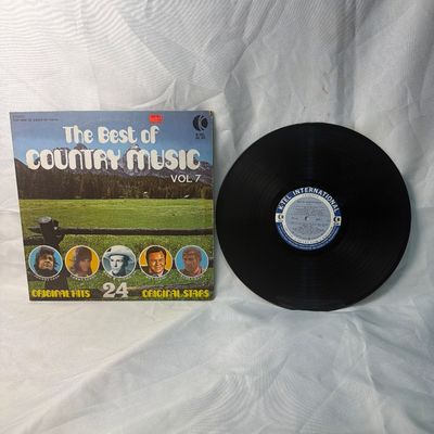 Sale Photo Thumbnail #63: Vintage vinyl record compilation album 'The Best of Country Music Vol. 7' released by K-Tel International (WU 325). Features 24 original hits by original stars including Johnny Cash, Donna Fargo, Hank Williams, Roy Clark, and Buck Owens. The cardboard sle