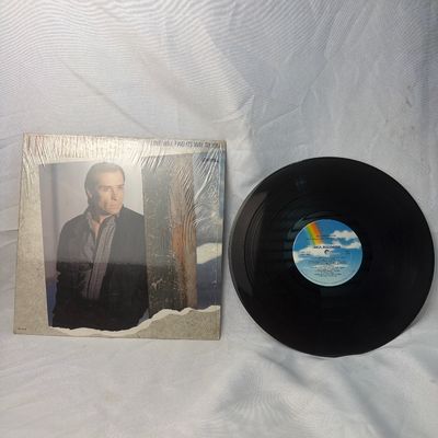 Sale Photo Thumbnail #17: Lee Greenwood "Love Will Find Its Way To You" vinyl record album, released on MCA Records (MCA-5766) in 1986. Includes the original outer sleeve which remains partially in its original shrink wrap. The vinyl disc features the classic rainbow MCA label. Sh