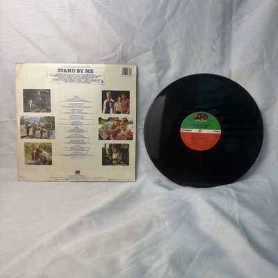 Sale Photo Thumbnail #40: Original Motion Picture Soundtrack for the film 'Stand By Me' on vinyl. Released on Atlantic Records. The outer sleeve remains in its original shrink wrap, showing some light storage wear. The vinyl record is included and appears to be in good pre-owned c