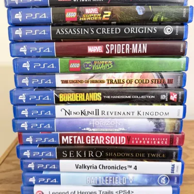 Stack of seventeen PlayStation 4 video games, including popular titles like Sekiro: Shadows Die Twice, Dark Souls Remastered, and...