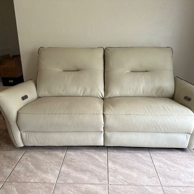 Beige Vegan Leather recliner couch, both seats recline independently & both arm rests have built in USB ports. Battery pack &...