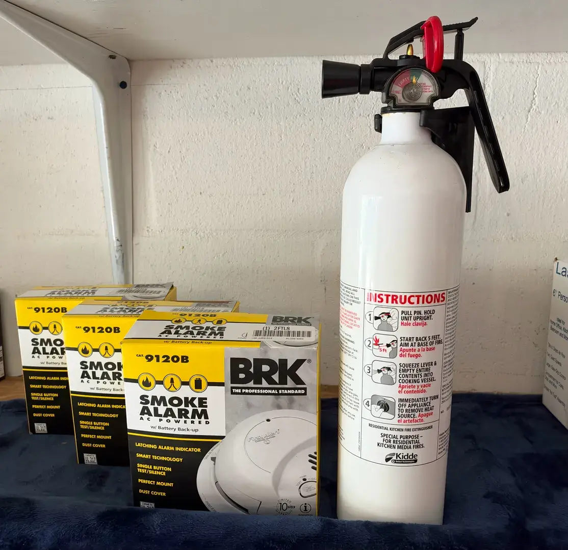 Fire safety gear, including hardwired ionization smoke alarms and a specialized kitchen fire extingu