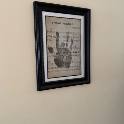 Framed Grateful Dead art print featuring Jerry Garcia's handprint superimposed over the sheet music for "Eyes of the...