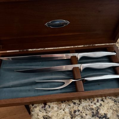 Vintage Carvel Hall carving set featuring two knives and a meat fork with sleek chrome handles, presented in its original velvet-lined...