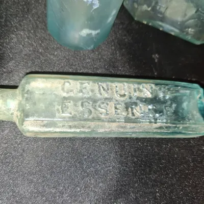 ANTIQUE BOTTLES WITH RAISED LETTERING