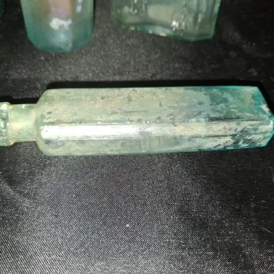 ANTIQUE BOTTLES WITH RAISED LETTERING