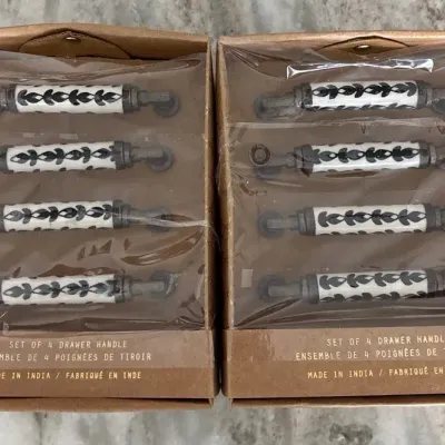 ceramic and metal drawer pull handles with a black-and-white botanical pattern in a box labeled
