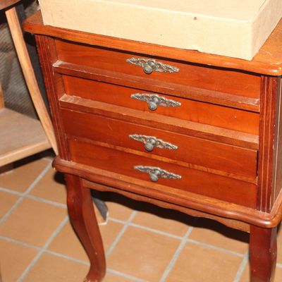 Vintage cherry finish four-drawer jewelry chest or side table with ornate metal hardware and cabriole legs.