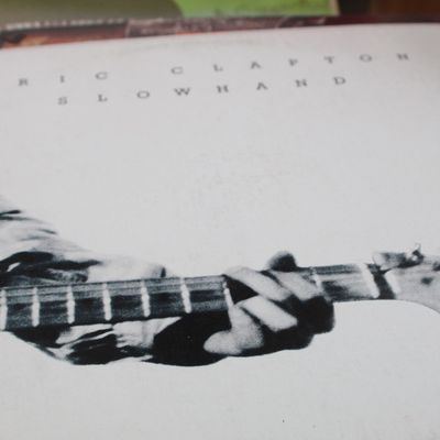 Eric Clapton "Slowhand" vinyl record album cover, released in 1977, showing light shelf wear.